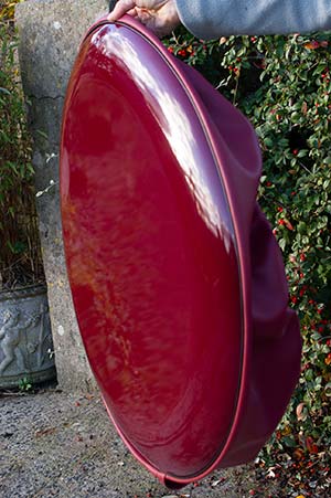 Wine red wheel cover disk with a wine red skirt.